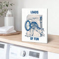 Navy cat and washer canvas styled above folded towels in a light laundry nook
