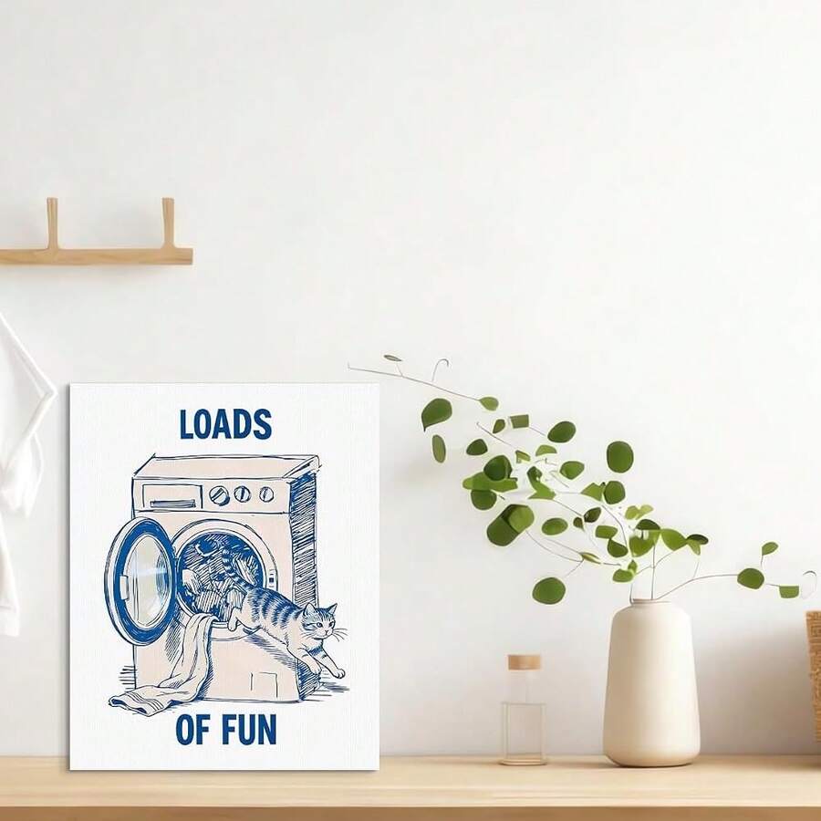 Blue cat laundry poster displayed on a bright shelf with a leafy plant