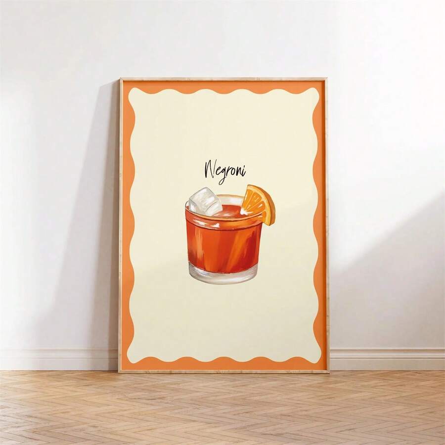 Framed Negroni cocktail poster with orange scalloped border and black handwritten title in a dining nook