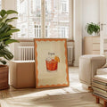 Retro Negroni cocktail artwork with orange border and cursive typography in a sunlit living room