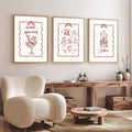 Three red Nordic Christmas canvas prints displayed in a living room