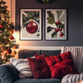 Christmas ornament and holly art above a sofa beside a lit tree and red cushions