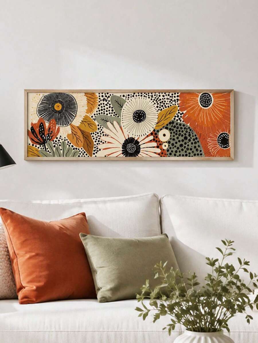 Horizontal floral canvas with bold blooms and black polka dots above a pale sofa
