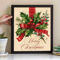 Framed vintage holly wall art with red berries and plaid ribbon