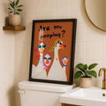 Funny goose typography wall art in a black frame above a toilet tank