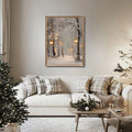 Framed snowy forest lantern print above a white sofa with plaid holiday pillows