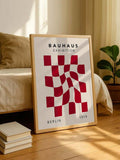 Bauhaus checkerboard wall art displayed above a red sofa in a modern living room