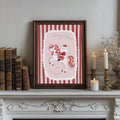 Santa unicorn Christmas poster in a dark frame above a decorative mantel
