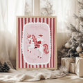 Framed Santa unicorn poster beside a decorated Christmas tree in a cozy bedroom