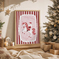Framed pink Santa riding a unicorn Christmas wall art beside a decorated tree
