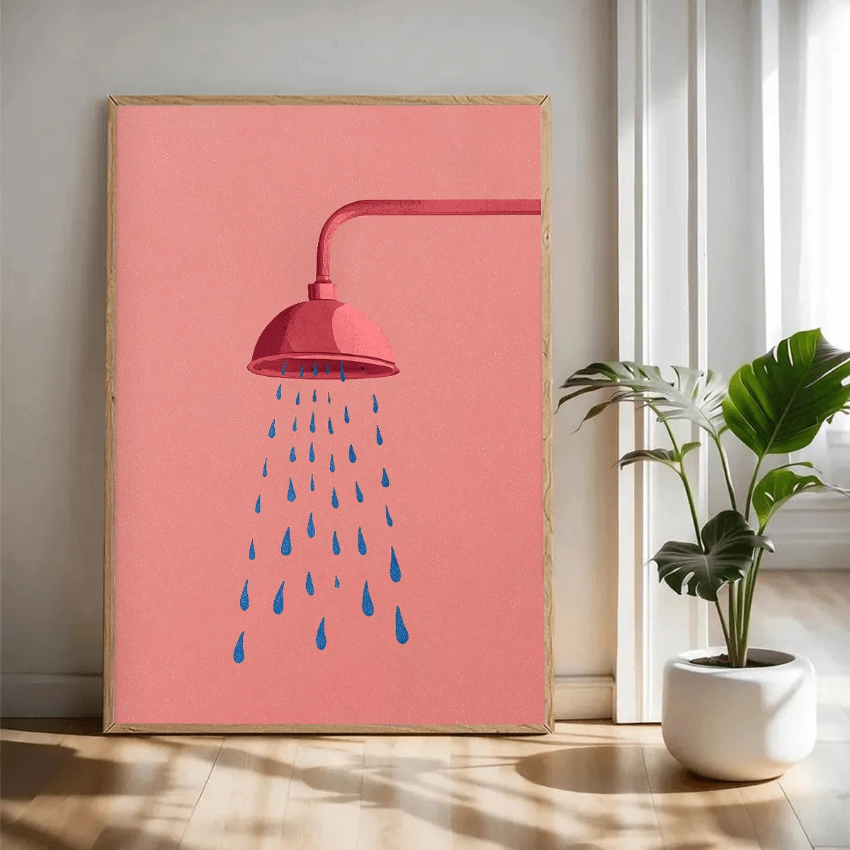 Pink shower canvas styled beside a leafy plant in a bright room