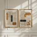 Cream ochre and black ridged plaster wall art in a sunlit room