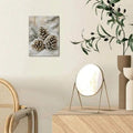 Pinecone winter wall art in a light wood and botanical interior