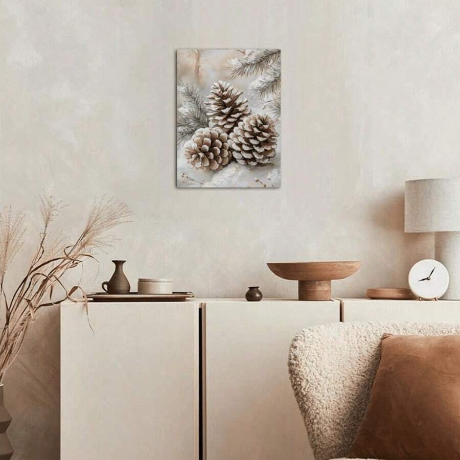 Neutral snowy pinecone poster displayed above a living room console