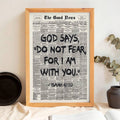 Light wood framed Isaiah 41:10 newspaper print styled with ceramics and greenery