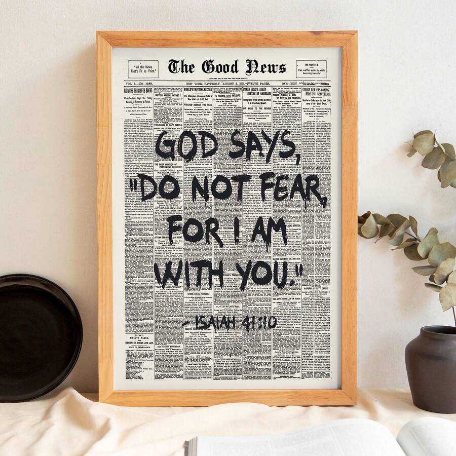 Light wood framed Isaiah 41:10 newspaper print styled with ceramics and greenery