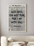 Unframed newspaper-style Isaiah 41:10 canvas with bold black lettering above a cream sofa