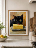 Whimsical black cat and butter kitchen wall art framed above a countertop