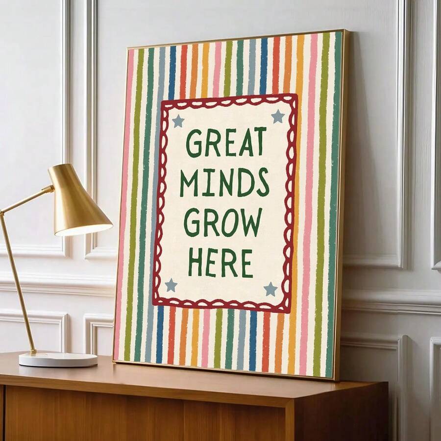 Inspirational striped poster on a desk beside a brass lamp and notebooks