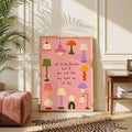 Groovy lamp wall art in a wood frame beside a mustard chair and record cabinet