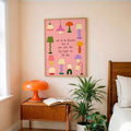 Colorful lamp artwork framed above a bedside table with an orange lamp