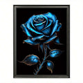 Dark framed blue rose botanical canvas poster against a white wall