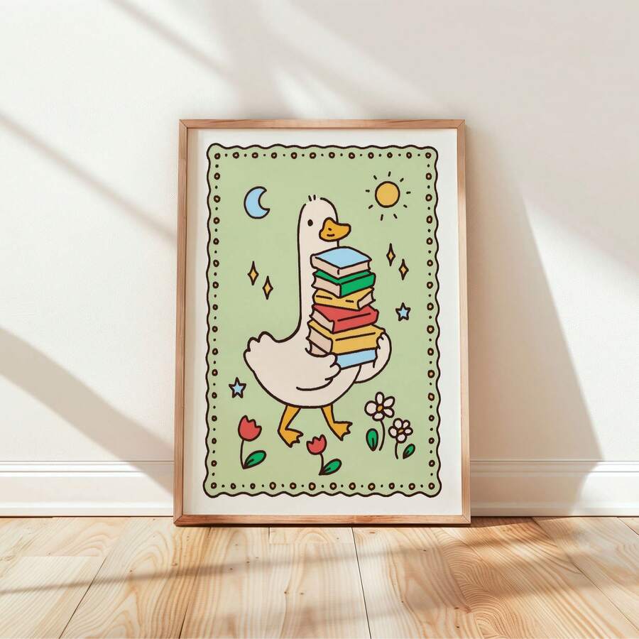 Cartoon goose with book stack and moon displayed in a simple wood frame against a sunlit wall