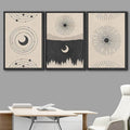 Three black-framed sun moon and stars posters displayed above a light desk and white chair
