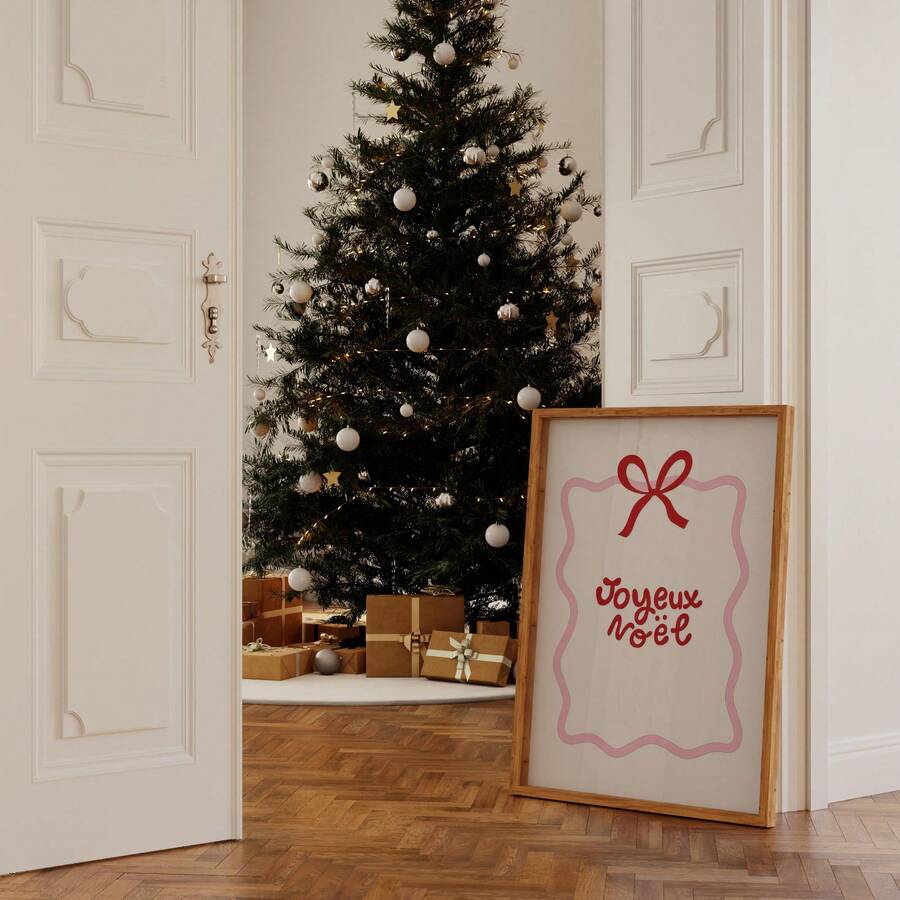 Joyeux Noël poster styled in a festive room by a decorated Christmas tree