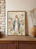 Floral Marian canvas in a wooden frame displayed against a light brick wall with a rustic vase