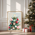 Framed ornament tree poster displayed beside a decorated Christmas tree and gifts