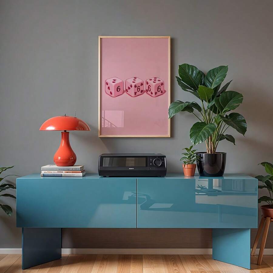Pink heart dice wall art in a light wood frame above a teal console