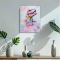 Pink dinosaur princess canvas in a bright room with green plants