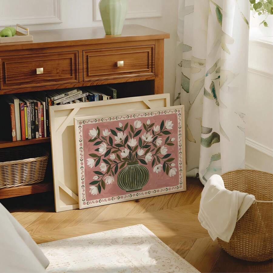 Framed magnolia floral canvas poster with white blossoms and green leaves in an olive vase