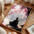 Close view of samurai artwork with cherry blossoms in a light wood frame