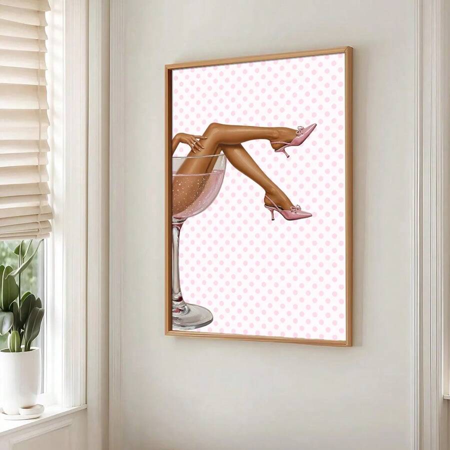 Pink martini fashion canvas poster in a gold frame beside a bright window and potted plant