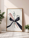 Hairstylist scissors and comb canvas artwork with a black bow in a gold-toned frame beside green potted plants