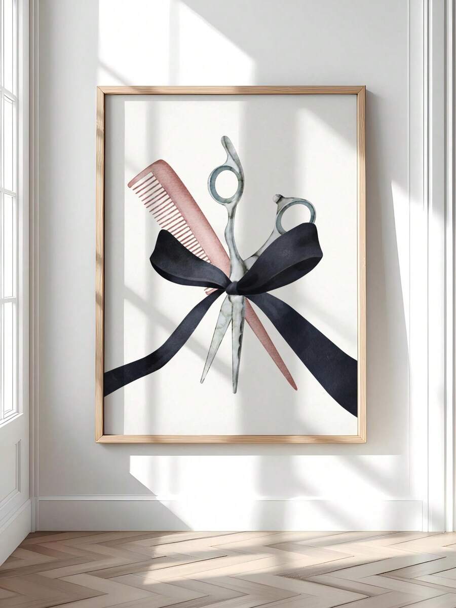 Watercolor scissors, pink comb and black bow artwork in a light wood frame on a bright wall beside a window