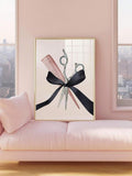 Scissors and comb watercolor artwork with a black ribbon bow in a gold-toned frame resting on a blush pink sofa