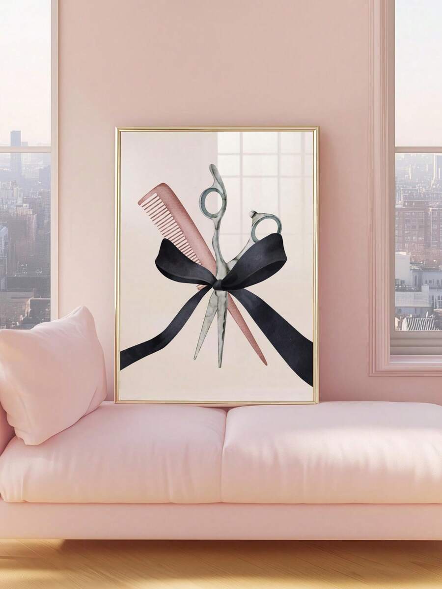 Scissors and comb watercolor artwork with a black ribbon bow in a gold-toned frame resting on a blush pink sofa