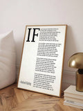 Angled light wood frame displaying Kipling poem print beside lamp and books