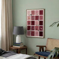 Burgundy cat checkerboard wall art in a bedroom with green wall