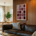 Burgundy cat checkerboard canvas poster displayed above a sofa on wood paneling