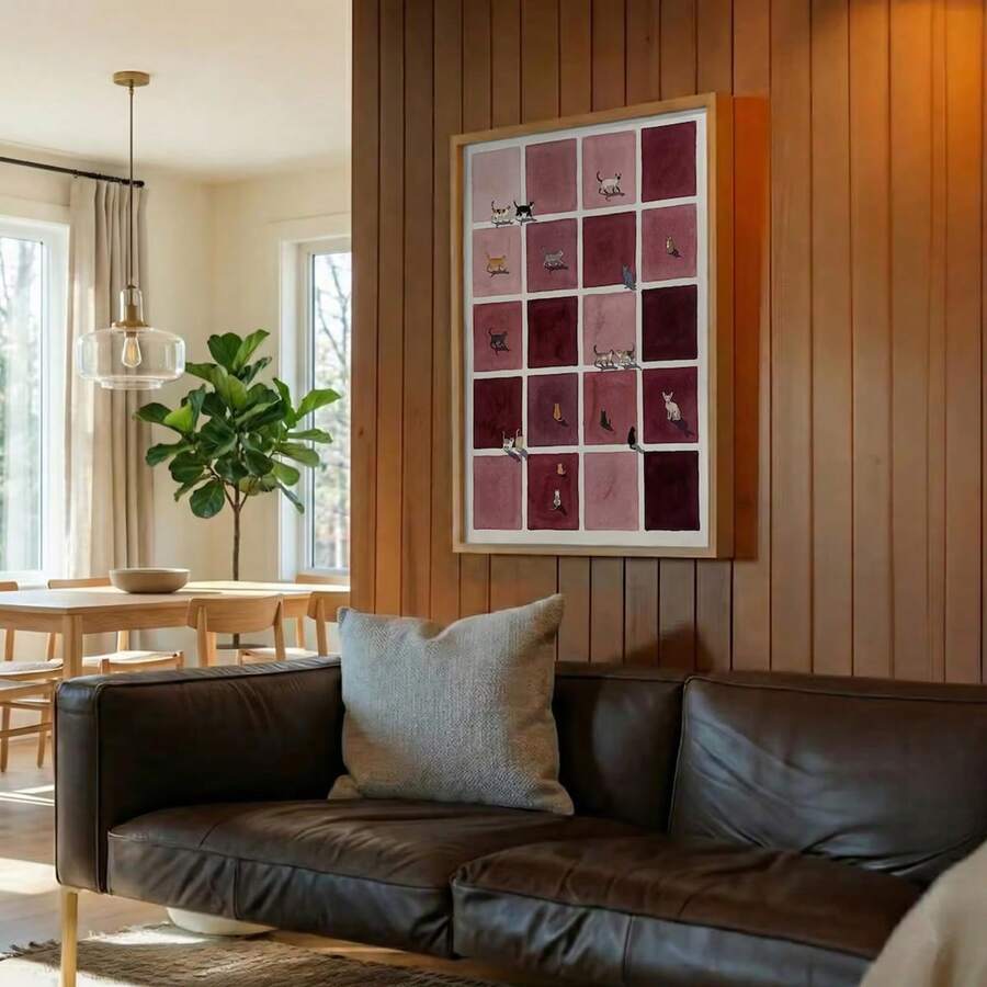 Burgundy cat checkerboard canvas poster displayed above a sofa on wood paneling