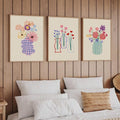 Colorful floral vase poster set on a wood-paneled bedroom wall above a bed
