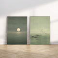 Unframed moonlit ocean and flock-of-birds canvas pair shown leaning against a wall