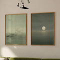 Two-piece moon and birds canvas set displayed together in natural wood frames