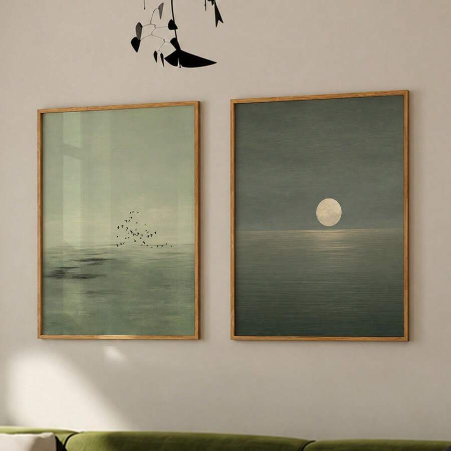 Two-piece moon and birds canvas set displayed together in natural wood frames