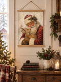 Framed vintage Santa deer poster displayed above a rustic sideboard with holiday greenery, berries, and candles