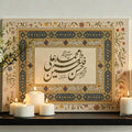 Close view of calligraphy print styled with lit candles and a floral border